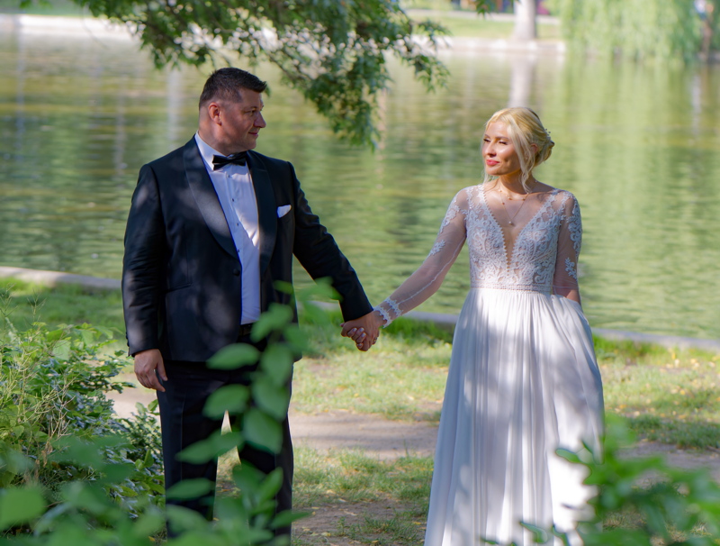 8 - Couple captured in a wedding portrait, with the woman wearing a long-sleeved lace wedding dress